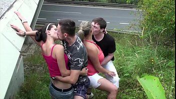 play Two bitches after the belt are fucked on the car by two men